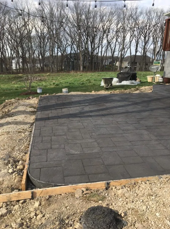 Stamped concrete slate pattern patio, dark charcoal finish