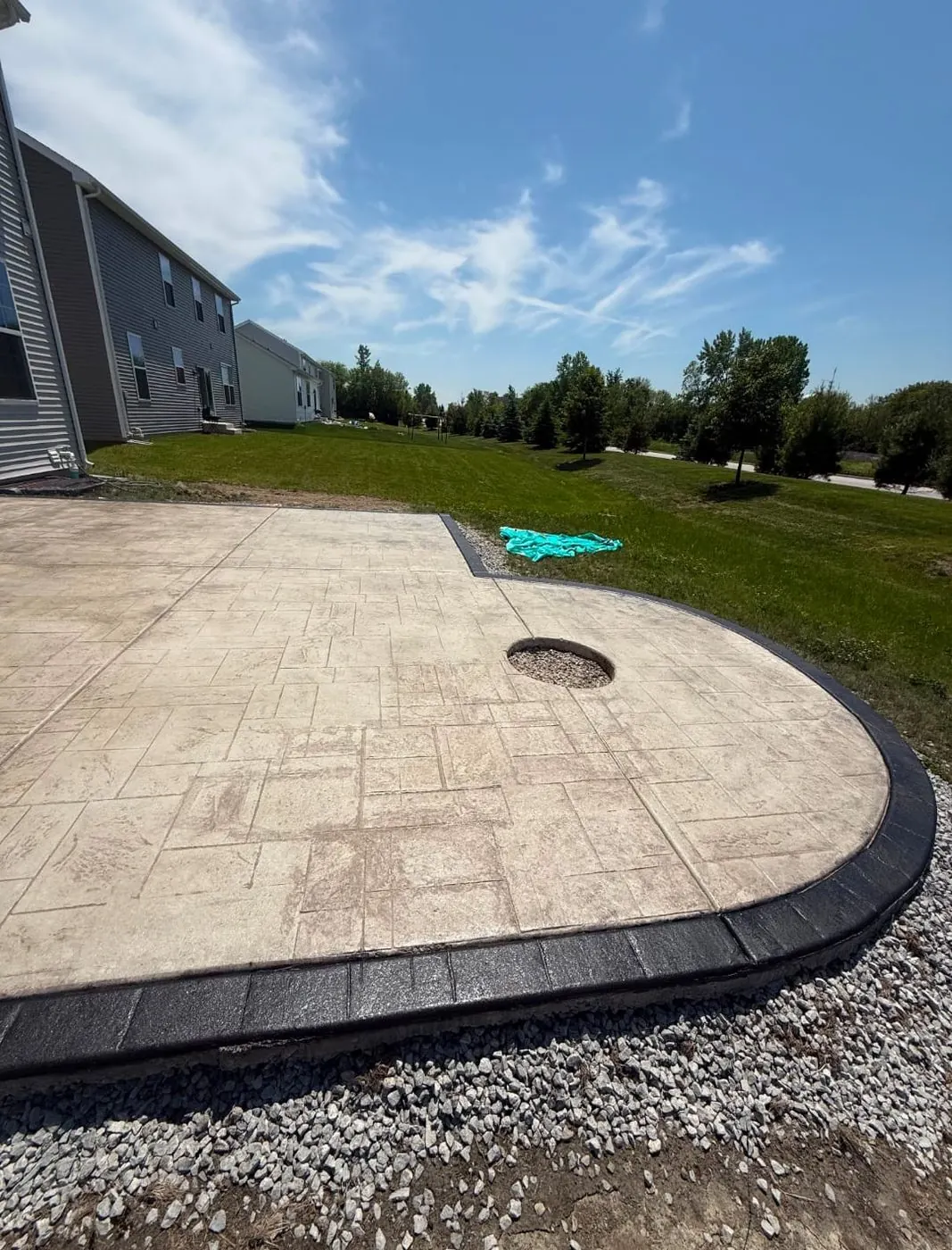 Stamped concrete patio with fire pit cutout